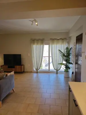 a living room with a couch and a tv at Tranquil 2BR Penthouse Petralona in Athens