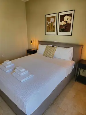 a bedroom with a large bed with towels on it at Tranquil 2BR Penthouse Petralona in Athens