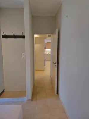 an empty hallway with a door and a tile floor at Tranquil 2BR Penthouse Petralona in Athens