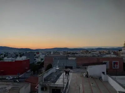 a view of a city from the roof of a building at Tranquil 2BR Penthouse Petralona in Athens