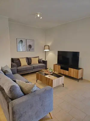 a living room with two couches and a flat screen tv at Tranquil 2BR Penthouse Petralona in Athens