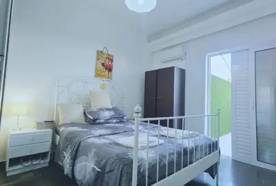 a bedroom with a bed and a refrigerator at 1\u53f7\u6c11\u5bbf in Athens