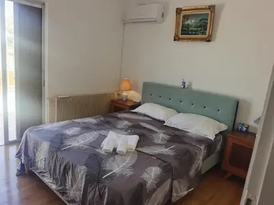 a bedroom with a bed with two towels on it at 1\u53f7\u6c11\u5bbf in Athens