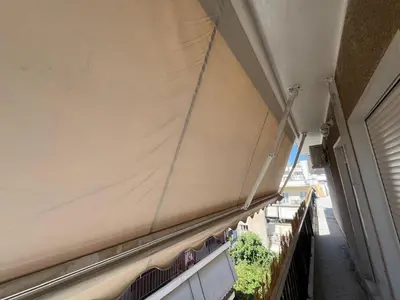 a side of a building with a curtain on it at For big family in Athens
