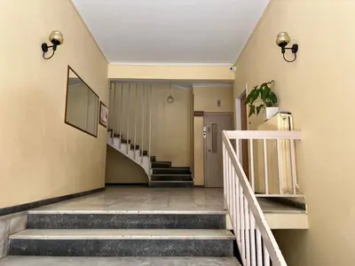 a hallway with stairs and a white railing at For big family in Athens
