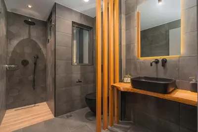 a bathroom with a black sink and a shower at Modern Urban Oasis with Private Plunge Pool in Piraeus