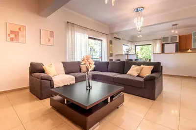 a living room with a couch and a coffee table at Phaedrus Living Moschato City Flat in Piraeus