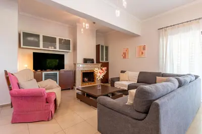 a living room with two couches and a tv at Phaedrus Living Moschato City Flat in Piraeus