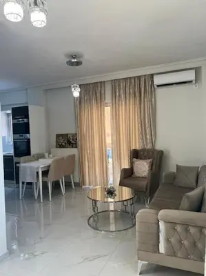 a living room with a couch and a table at Modern and comfortable apartment 5km from center in Athens
