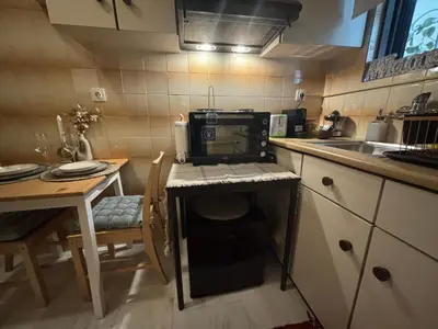 a small kitchen with a table and a sink at Garden Vibes Glyfada in Athens