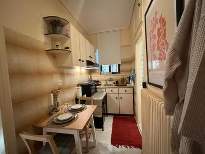 a small kitchen with a table in a small room at Garden Vibes Glyfada in Athens