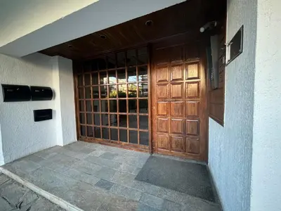 an entrance to a house with a wooden door at Garden Vibes Glyfada in Athens