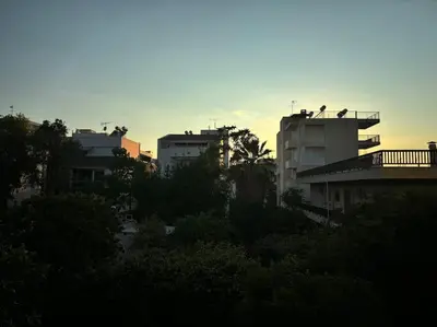 a group of buildings in a city with birds on the roof at Garden Vibes Glyfada in Athens