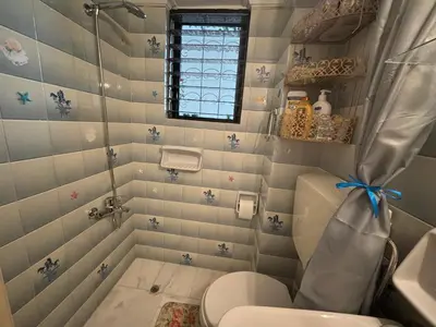 a small bathroom with a toilet and a window at Garden Vibes Glyfada in Athens