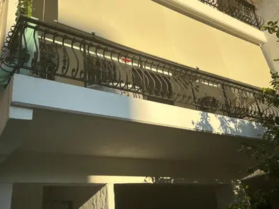 a balcony on the side of a building at Garden Vibes Glyfada in Athens