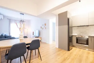 a kitchen and dining room with a table and chairs at Urban Comfort 2 bdrm next to Metro in Athens