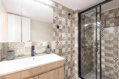 a bathroom with a sink and a shower at Urban Comfort 2 bdrm next to Metro in Athens