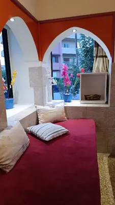 a room with two pillows on a red carpet at 4 Seasons Suites Paradise Near Airport And Beach 2 in Markopoulo