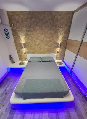 a large bed in a room with purple lights at Island 3siblings in Athens