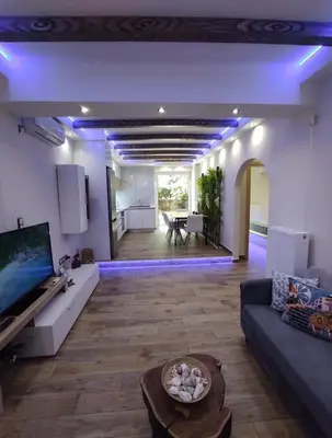 a living room with a couch and a table at Island 3siblings in Athens
