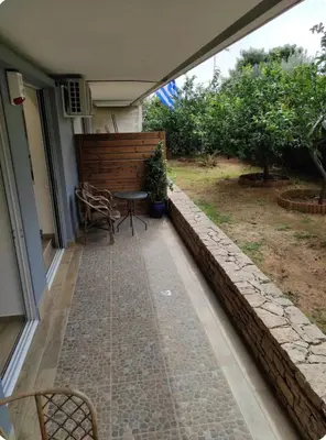 a patio of a house with a table and chairs at Island 3siblings in Athens