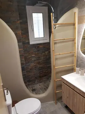 a bathroom with a toilet and a sink and a window at Island 3siblings in Athens