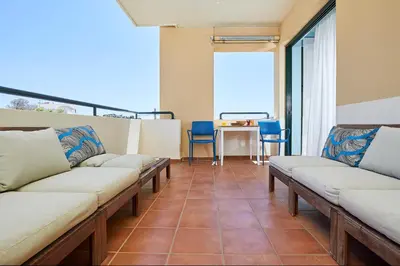 a living room with couches and a table with chairs at soft blue apartment near seaside in Porto Rafti