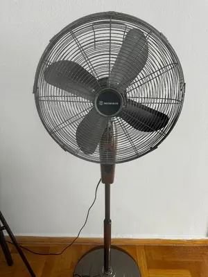 a black fan sitting on top of a wooden floor at Spartan Residence in Athens