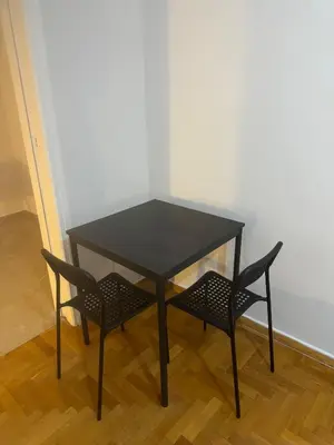 a black table and two chairs in a room at Spartan Residence in Athens
