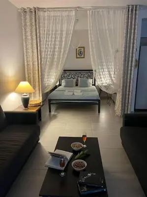a living room with a couch and a table at Aurora Studio Lagonissi in Lagonissi