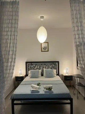 a bedroom with a bed with towels on it at Aurora Studio Lagonissi in Lagonissi