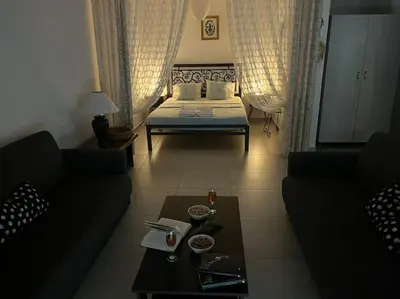 a living room with a bed and a coffee table at Aurora Studio Lagonissi in Lagonissi