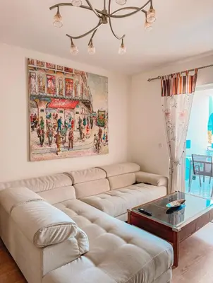 a living room with a couch and a painting on the wall at Aegean Pearl in Porto Rafti
