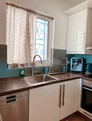 a kitchen with a sink and a window at Aegean Pearl in Porto Rafti