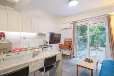 a kitchen with a counter and a dining room at Athens4U Pagrati 1Gbps Near Metro in Athens