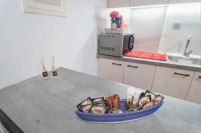 a bowl of utensils on a counter in a kitchen at Athens4U Pagrati 1Gbps Near Metro in Athens