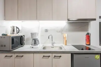 a kitchen with a sink and a microwave at Athens4U Pagrati 1Gbps Near Metro in Athens