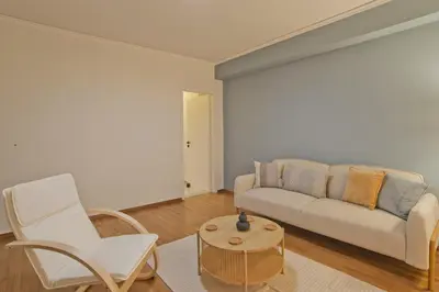 a living room with a couch and a table and chairs at Hill House Lycabettus Stylish near Athens Center in Athens