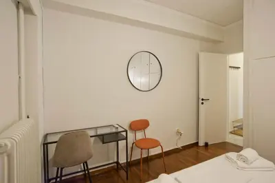 a room with two chairs and a glass desk at Hill House Lycabettus Stylish near Athens Center in Athens