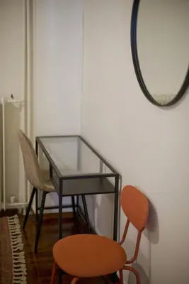 a glass table with two chairs and a mirror at Hill House Lycabettus Stylish near Athens Center in Athens