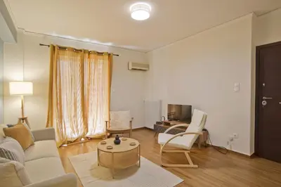 a living room with a couch and a table at Hill House Lycabettus Stylish near Athens Center in Athens