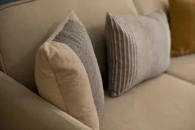 a couch with two pillows sitting on it at Hill House Lycabettus Stylish near Athens Center in Athens