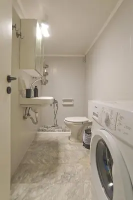 a bathroom with a washing machine and a sink at Hill House Lycabettus Stylish near Athens Center in Athens