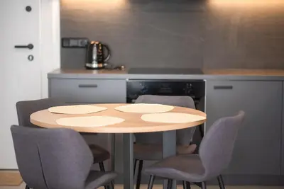 a kitchen with a wooden table and chairs at Stylish Comfort Apt in Athens Centre in Athens