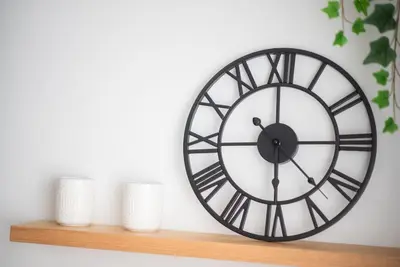 a black and white clock on a shelf with cups at Stylish Comfort Apt in Athens Centre in Athens