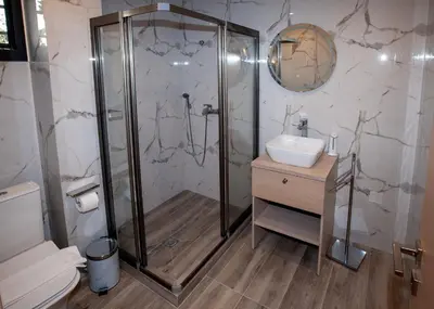 a bathroom with a shower and a sink at Sia's Retreat 1 Modern Apt Athens Riviera in Athens