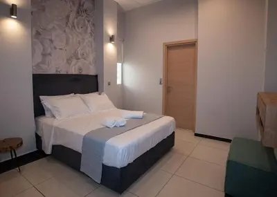 a bedroom with a large bed with two towels on it at Sia's Retreat 1 Modern Apt Athens Riviera in Athens