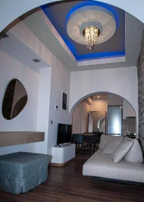 a living room with a bed and a dining room at Sia's Retreat 2 Modern Apt Athens Riviera in Athens