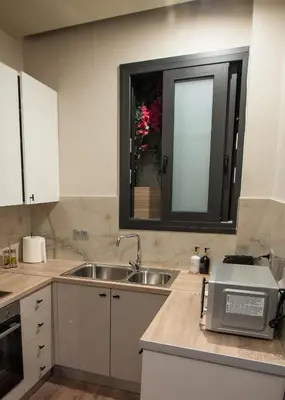 a kitchen with a sink and a window at Sia's Retreat 2 Modern Apt Athens Riviera in Athens