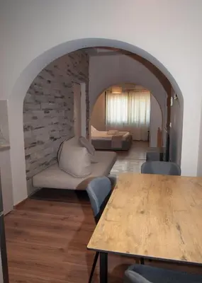 a living room with a table and a bedroom at Sia's Retreat 2 Modern Apt Athens Riviera in Athens